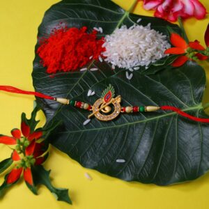 Krishna Flute Rakhi with Stone-Studded Peacock Feather Design