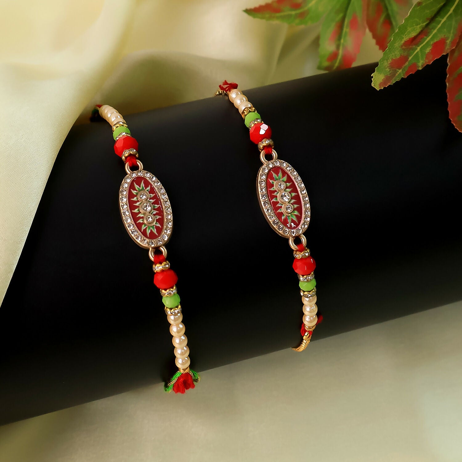 Elegant Bhaiya Bhabhi Rakhi Set – Designer Red Oval Dial Rakhi with Pearl Beads and Adjustable Golden Bracelet