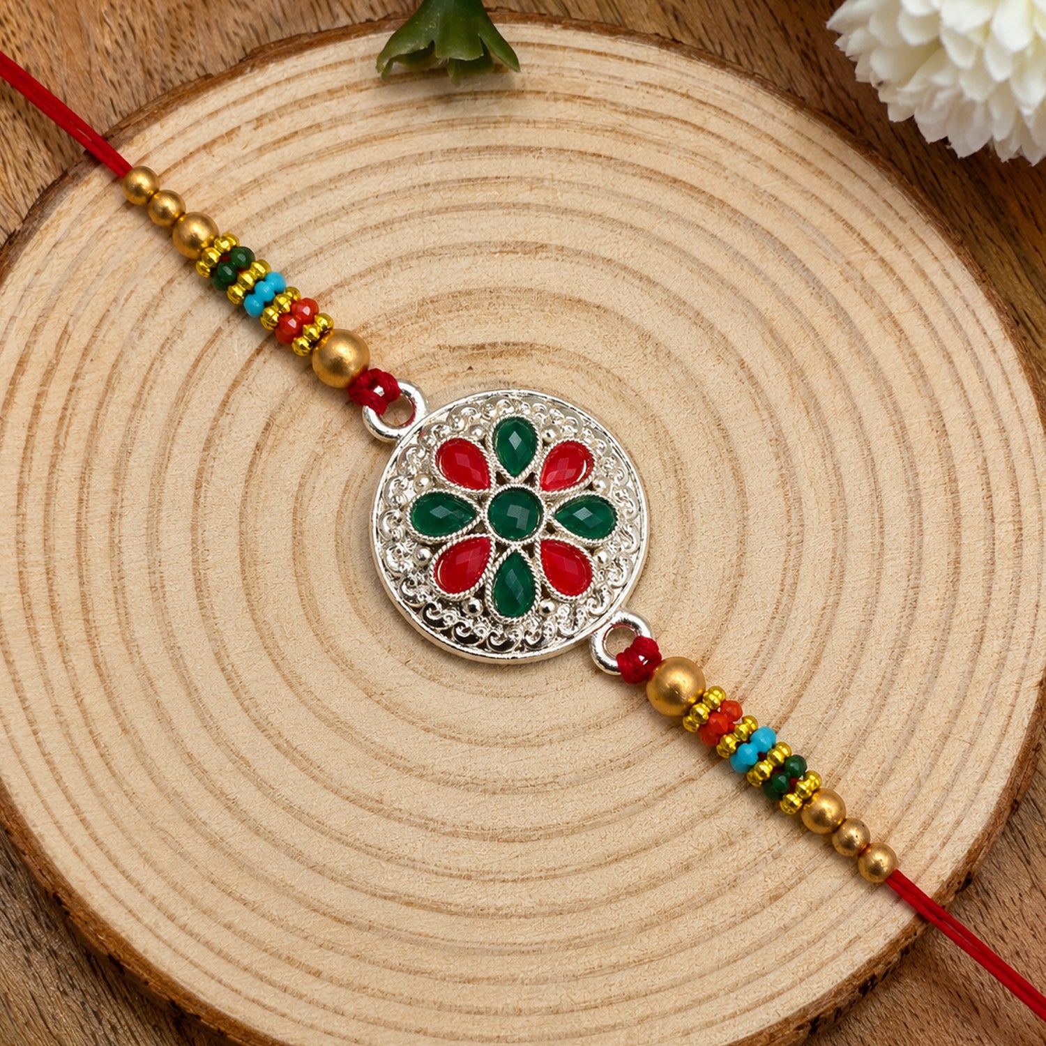Silver Plated Floral Rakhi with Red & Green Stones