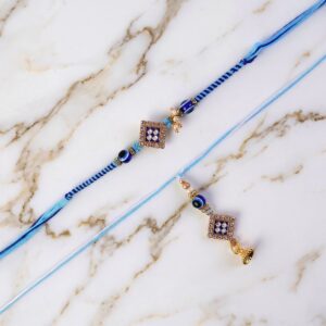 Packaged Pearl Bhabhi Rakhi with Twin Charm Design